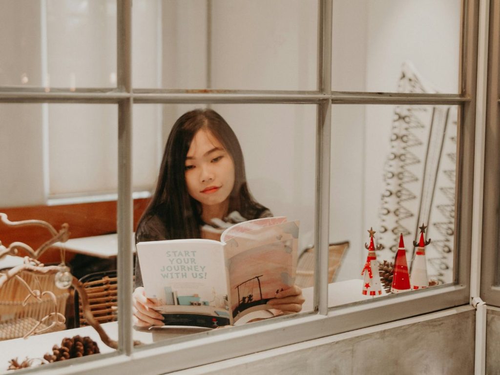 Girl reading magazine in asia